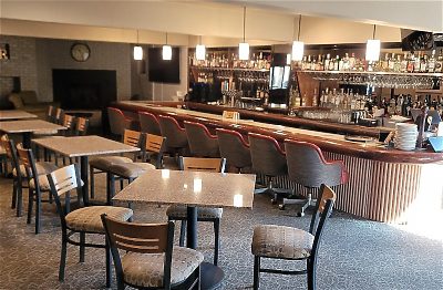 Lous Public House bar area with seating and a wide selection of beverages